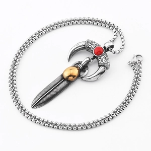 Vintage hip hop style necklace featuring horn, red bead, and feather pendants on box chain
