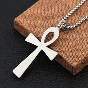 Dettaglio macro del ciondolo croce Ankh argento spazzolato con catena a maglie quadre