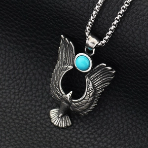 Collier avec pendentif aigle vintage et pierre turquoise sur fond cuir noir