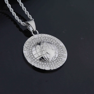 Detail of silver earth pendant with zircons and Shared Future for Mankind engraving