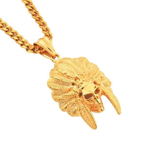 Detailed view of gold Indian feather headdress skull pendant on a Cuban link chain