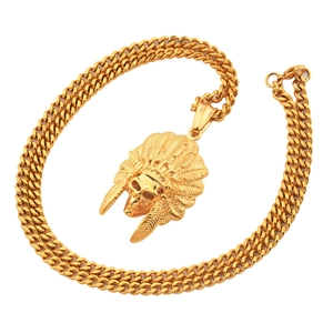 Close-up of golden Indian skull pendant on chunky Cuban chain necklace for men