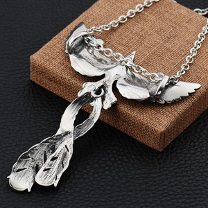 Vintage silver phoenix pendant necklace with detailed feather textures and thick chain link