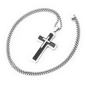 Detailed macro of a triple-layered cross pendant with silver and black metallic finish