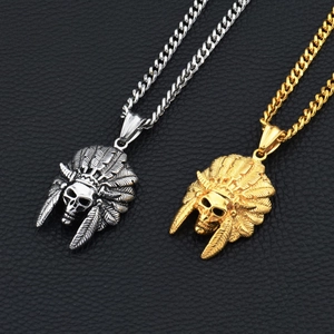 Detailed macro view of gold and silver Indian skull pendants with feather headdress