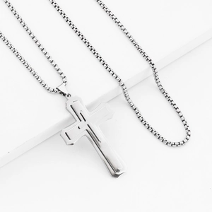 Detail of silver triple-layered cross pendant with sleek stainless steel box chain