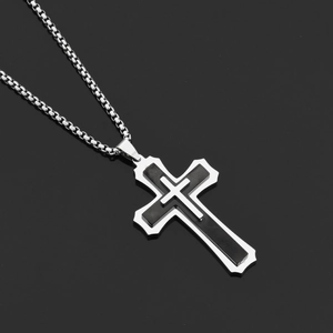 Macro shot of polished triple-layered cross pendant with black inlay and box chain