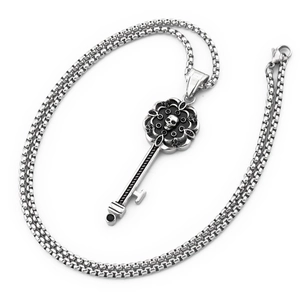 Macro shot of gothic skull key pendant with black crystal accents and box chain