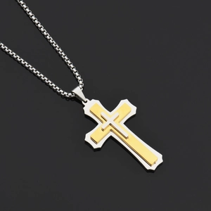 Detail of three-layer cross pendant with gold and silver finish on a box chain necklace