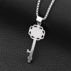 Polished stainless steel skeleton key pendant necklace on box chain and leather background