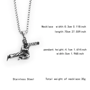 Detail view of martial arts pendant showing size measurements and stainless steel texture