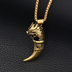 Golden dragon wolf tooth pendant necklace with embossed texture on black leather
