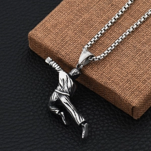 Detail of vintage kung fu fighter pendant on square pearl chain with textured finish
