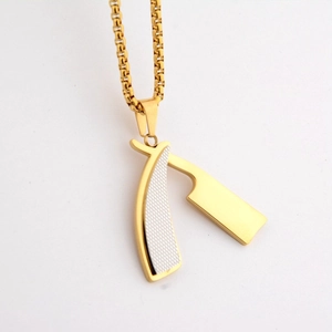 Detailed macro view of vintage razor pendant with white grid inlay on a gold box chain