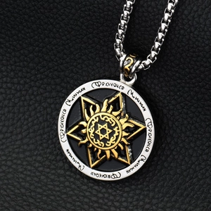 Detail of a tri-color hexagram sun medallion pendant on a heavy metal curb chain