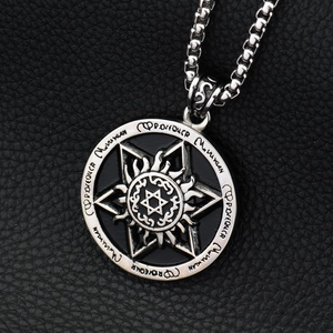 Macro view of the silver star pendant featuring intricate engravings and a black enamel finish