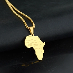 Close-up of gold Africa map pendant with engraved city names on a box chain