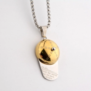 Macro detail of baseball cap pendant featuring Keep Me Warm engraving and gold accents