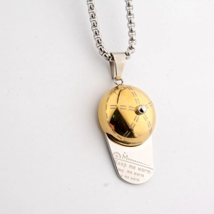 Detailed close-up of a hip hop baseball cap pendant necklace with Keep me warm engraving