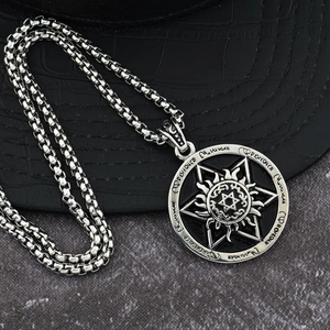 Detailed close-up of hexagram sun pendant with gothic symbols on a steel chain