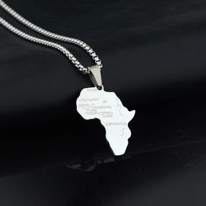 Detailed close-up of a silver Africa map pendant with laser engraving on a box chain