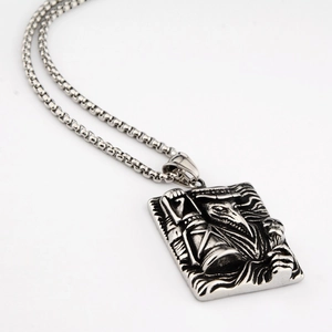 Macro view of vintage plague doctor embossed pendant on a stainless steel chain