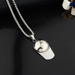 Close-up of hip-hop silver baseball cap pendant with keep me warm engraving