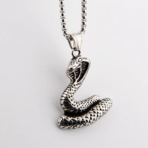Detailed view of silver cobra pendant with textured snake scales on steel chain