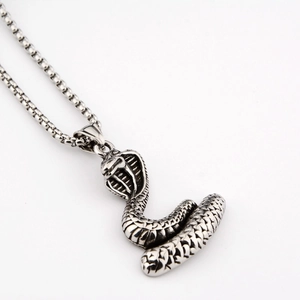Detailed close-up of a stainless steel cobra snake pendant featuring intricate scales