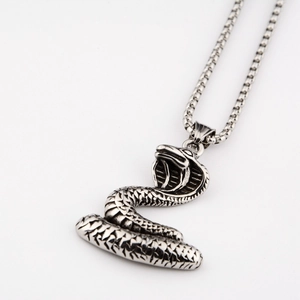 Close-up of hip-hop cobra pendant with detailed scale texture and thick steel chain