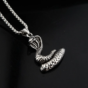 Edgy stainless steel cobra snake pendant necklace with bead chain on black background
