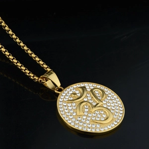 Gold Om pendant necklace with sparkling crystal inlay on a stylish box chain