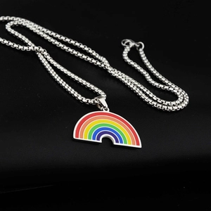 Rainbow pendant necklace in polished titanium steel on black textured background