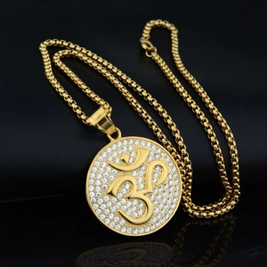 Gold Om pendant necklace with sparkling rhinestones and box chain on black background