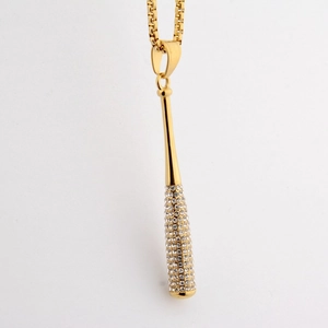 Detail view of gold hip-hop baseball bat pendant with sparkling inlaid rhinestones
