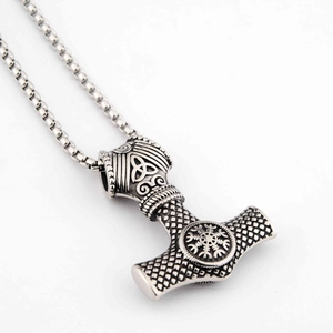 Close-up of vintage silver Mjolnir pendant with Norse runes and box chain necklace