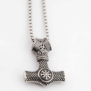 Macro shot of Viking Mjolnir pendant with Vegvisir symbol on a stainless steel chain