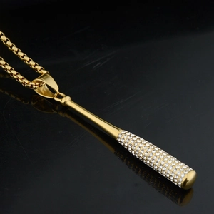 Macro shot of gold-plated baseball bat pendant with sparkling iced-out rhinestones