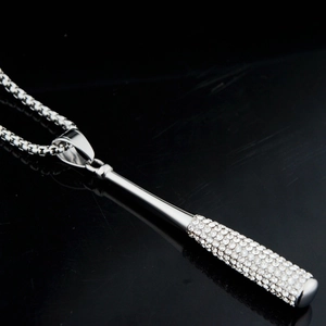 Macro shot of polished silver baseball bat pendant with sparkling micro-pave crystals