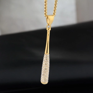 Macro shot of gold-plated baseball bat pendant with sparkling crystals and box chain link