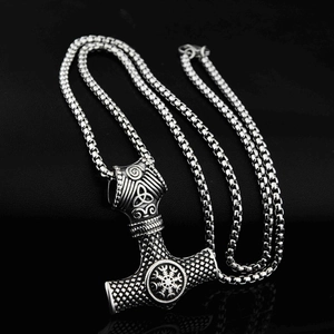 Detailed macro view of Viking Mjölnir pendant featuring runic compass and Celtic knot motifs.