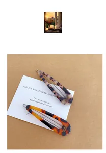 Detail of two French vintage tortoise shell water drop hair clips on a card