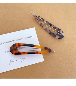Detail of French vintage tortoise shell hair clips with metal snap and gold engraving