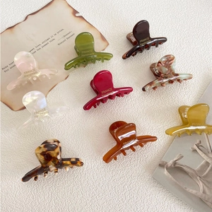 Macro shot of acetic acid hair clips featuring France Handmade text and various marble textures