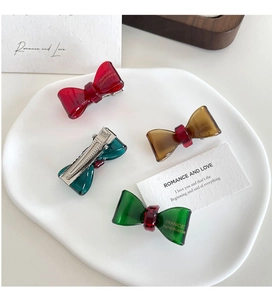 Close-up of colorful resin bow hair clips with France Handmade gold lettering detail