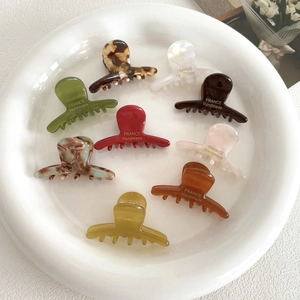 Acetate mini hair claw clip set in various colors like marble and amber textures