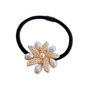 Elegant floral hair tie with pearl center and golden alloy petals on elastic black rope