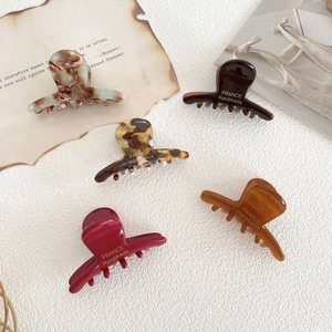 Five pieces of small acetate hair claw clips in tortoise shell and solid colors set