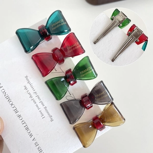 Set of five colorful bow-shaped hair clips in resin with metallic crocodile clips