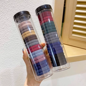 Elastic hair ties set in colorful Morandi tones within a transparent cylindrical container